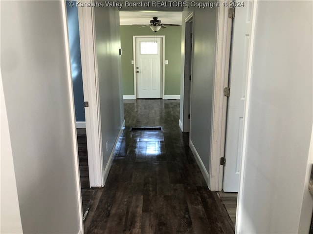 hallway with dark hardwood / wood-style floors