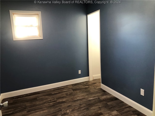 spare room featuring dark hardwood / wood-style floors