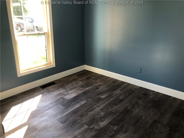 spare room with wood-type flooring