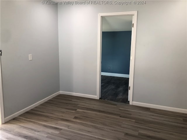 empty room with dark hardwood / wood-style floors