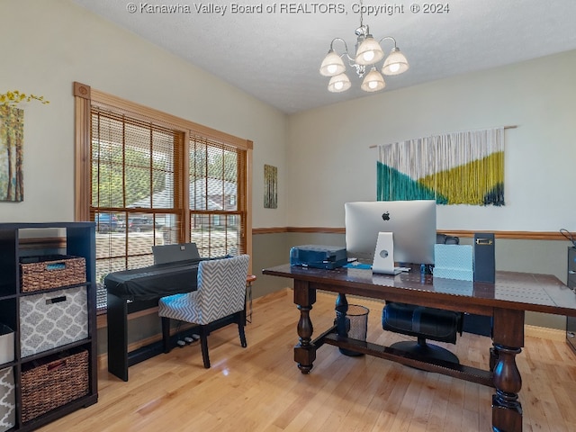 office area featuring a textured ceiling, light hardwood / wood-style flooring, and a notable chandelier