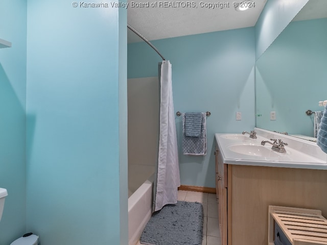 bathroom featuring shower / bath combination with curtain, vanity, a textured ceiling, and tile patterned floors