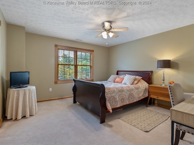 carpeted bedroom featuring a textured ceiling and ceiling fan