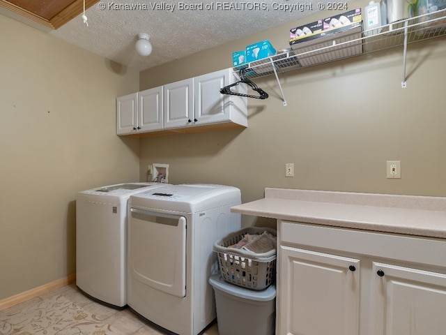 clothes washing area featuring washing machine and dryer, cabinets, a textured ceiling, and light tile patterned flooring