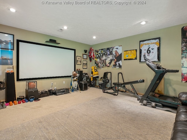 carpeted cinema featuring a textured ceiling