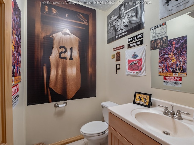 bathroom with vanity, tile patterned floors, and toilet