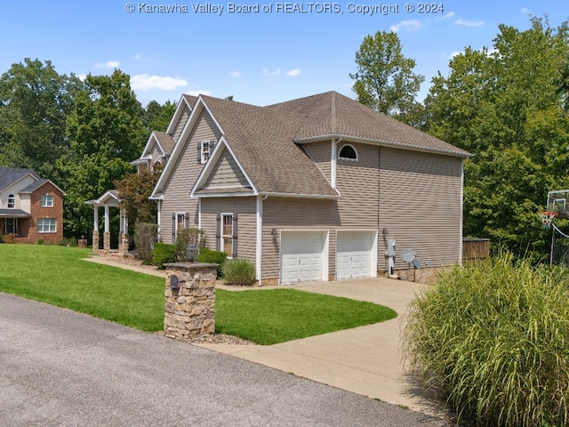 view of front of property featuring a garage and a front lawn