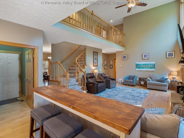 dining room featuring a textured ceiling, light hardwood / wood-style floors, and ceiling fan