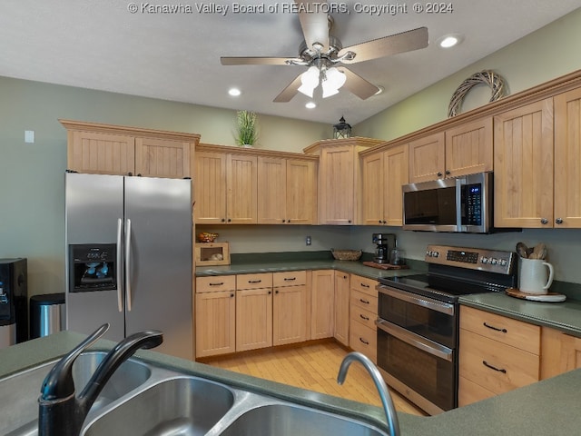 kitchen with appliances with stainless steel finishes, light brown cabinets, sink, light hardwood / wood-style floors, and ceiling fan