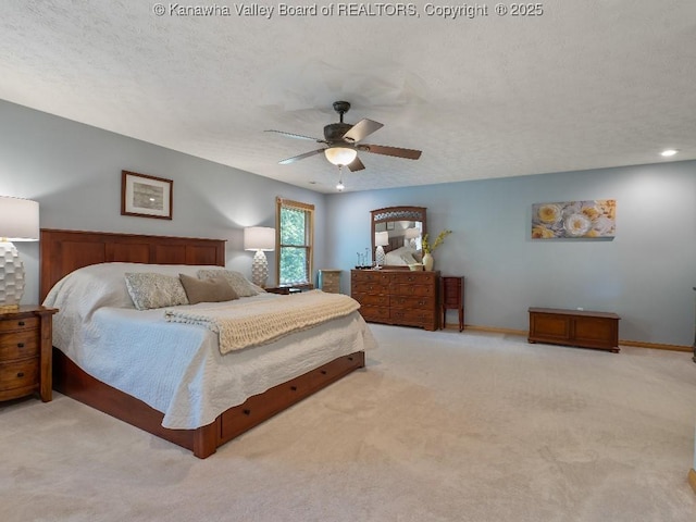 bedroom with light carpet, ceiling fan, and a textured ceiling