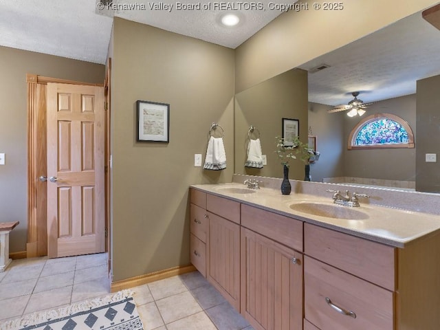 bathroom with a textured ceiling, vanity, tile patterned flooring, and ceiling fan