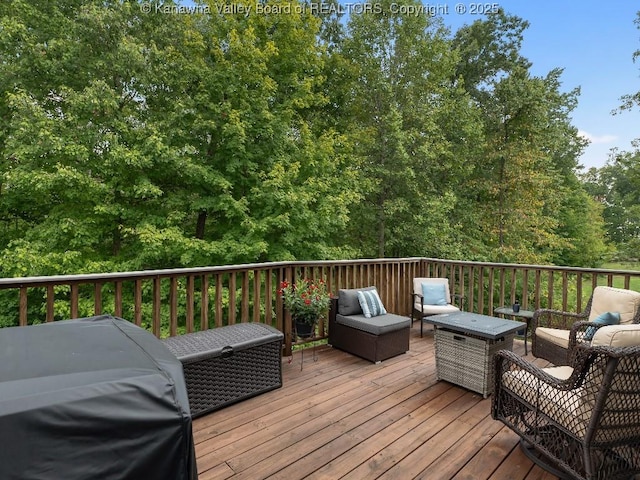 deck featuring an outdoor living space and a grill