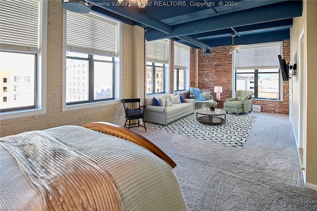 interior space featuring brick wall, beamed ceiling, and carpet flooring