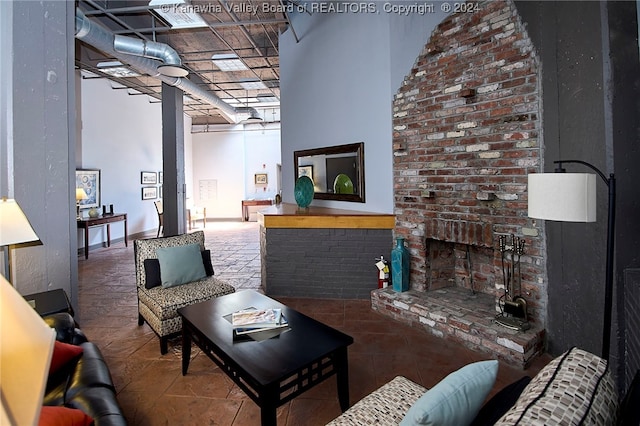 living room featuring a brick fireplace