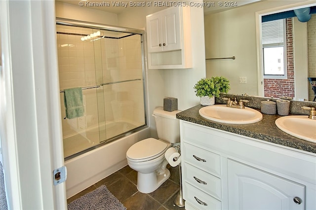 full bathroom with tile patterned floors, toilet, vanity, and enclosed tub / shower combo