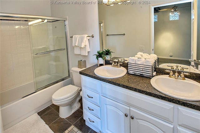 full bathroom featuring bath / shower combo with glass door, ceiling fan, vanity, and toilet