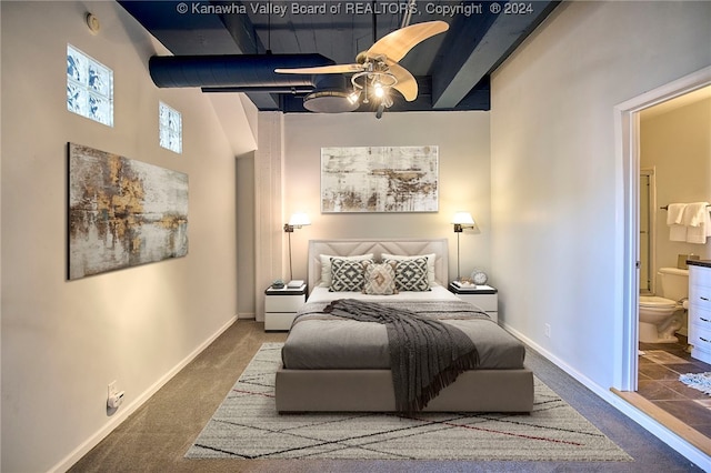 carpeted bedroom featuring ceiling fan, connected bathroom, and a towering ceiling