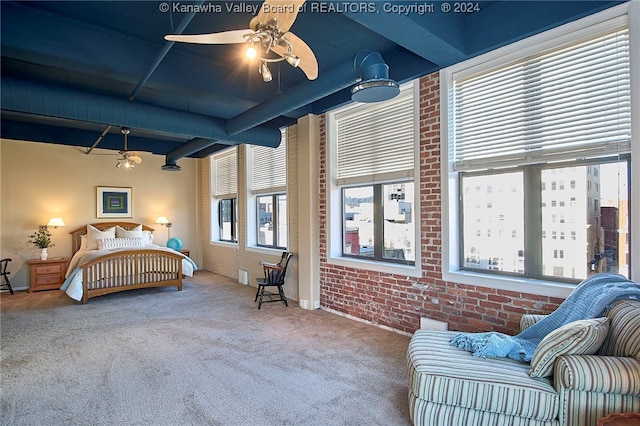 bedroom with carpet, ceiling fan, and brick wall