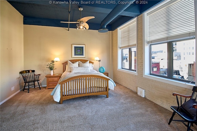 bedroom with brick wall, carpet, and ceiling fan