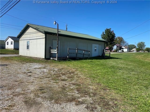 view of outbuilding with a lawn