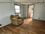 sitting room with dark hardwood / wood-style flooring