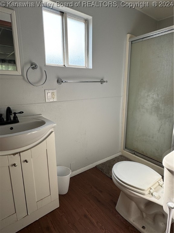 bathroom with vanity, toilet, wood-type flooring, and an enclosed shower