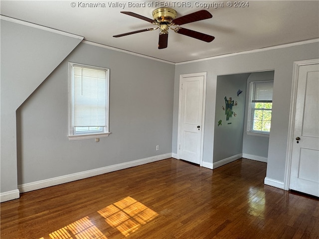 unfurnished bedroom with crown molding, ceiling fan, and dark hardwood / wood-style flooring