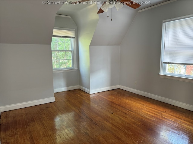 additional living space featuring vaulted ceiling, ceiling fan, dark hardwood / wood-style floors, and plenty of natural light