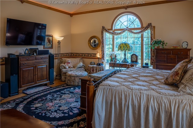 bedroom with crown molding and hardwood / wood-style floors