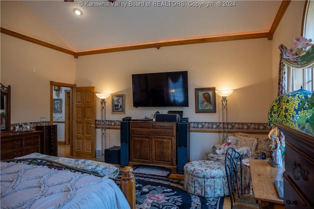 bedroom with lofted ceiling and ornamental molding