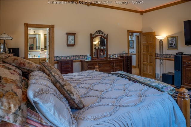 bedroom featuring connected bathroom and crown molding