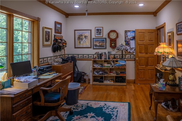 home office with crown molding and light hardwood / wood-style flooring