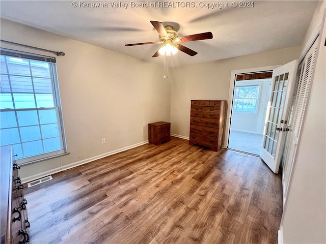 interior space with french doors, a textured ceiling, hardwood / wood-style flooring, and ceiling fan