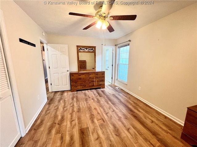 unfurnished bedroom with light hardwood / wood-style floors and ceiling fan