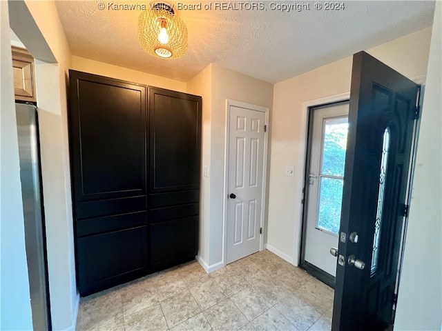 entrance foyer featuring a textured ceiling