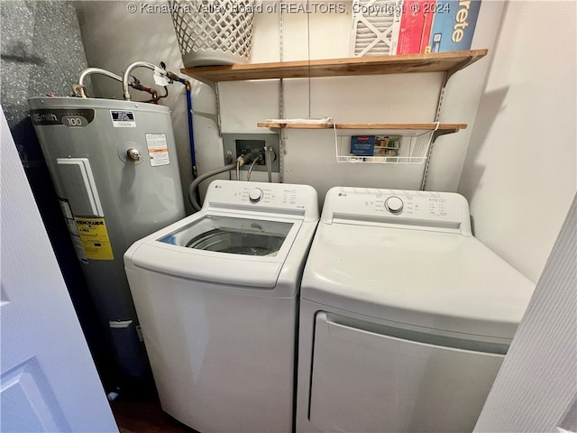 laundry room with electric water heater and washing machine and dryer