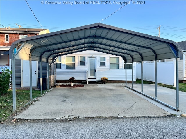 view of parking / parking lot featuring a carport