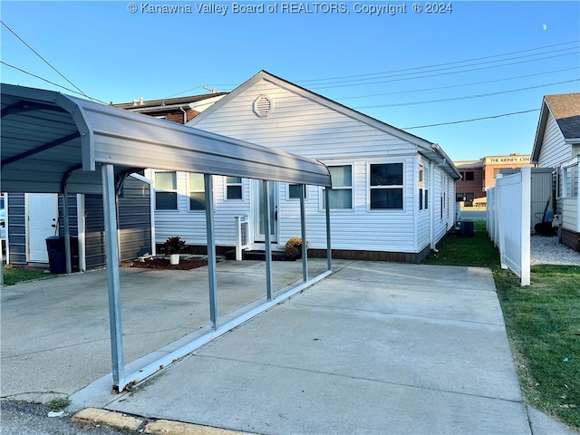 view of front of home featuring a carport and central AC