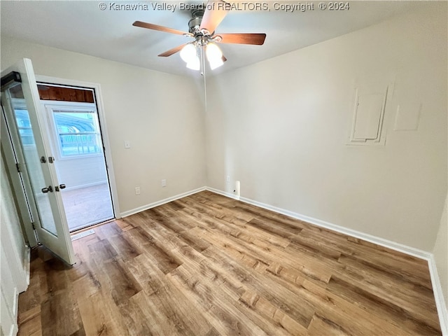 empty room with ceiling fan and light wood-type flooring