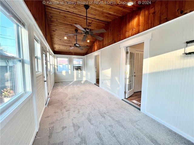 unfurnished sunroom featuring vaulted ceiling, ceiling fan, and wooden ceiling