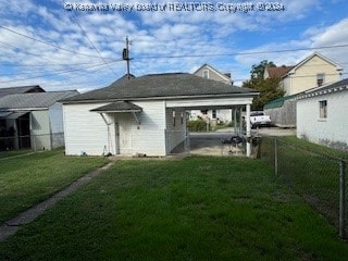 rear view of house with a lawn and a patio area