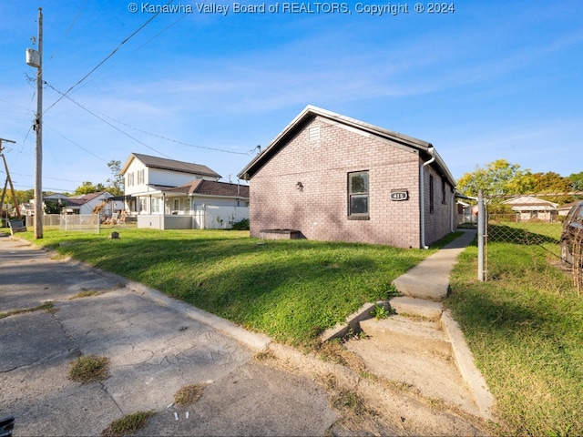 view of side of property featuring a yard