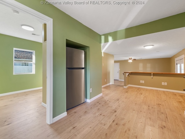 interior space with light hardwood / wood-style floors, ceiling fan, and a wealth of natural light