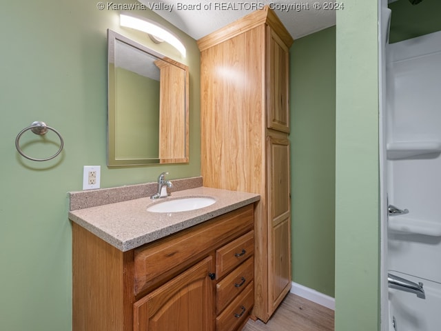 bathroom with vanity and hardwood / wood-style floors