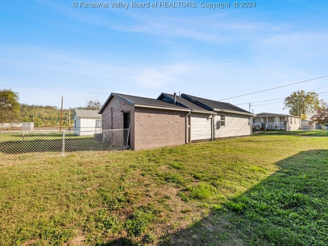 view of property exterior featuring a lawn