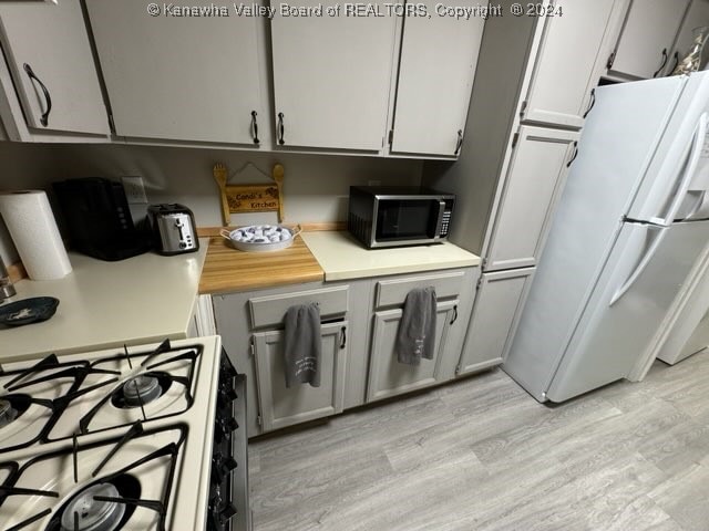 kitchen featuring white appliances and light wood-type flooring