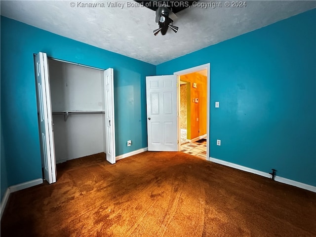 unfurnished bedroom featuring a textured ceiling, carpet floors, and a closet