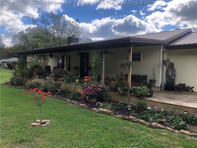 rear view of property featuring a lawn