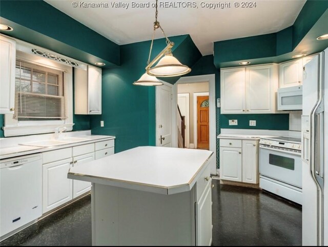 kitchen with white cabinets, light countertops, white appliances, and a sink