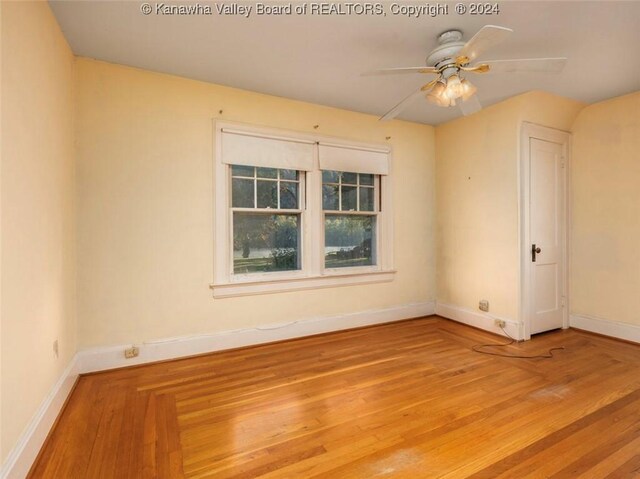 unfurnished room featuring ceiling fan, baseboards, and wood finished floors